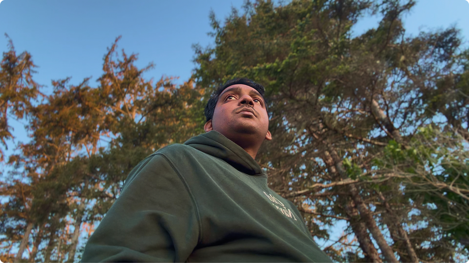 Tharun Josh outdoors under tall trees
